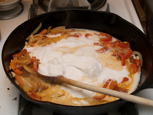 Adding the coconut milk to the sautéed veggies Thai Red Curry Shrimp