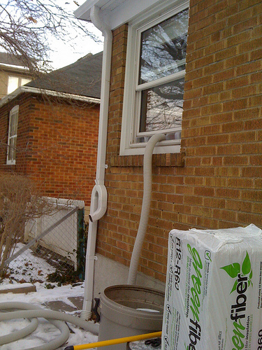 The tube carrying the insulation to the attic