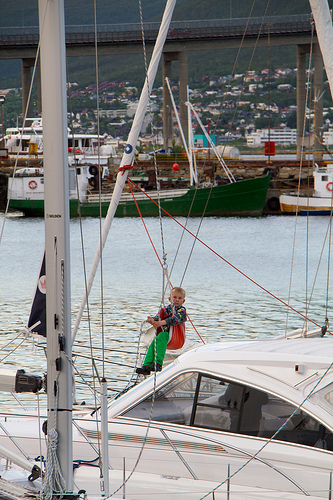 Kid swinging on a boat, Tromsø, Norway